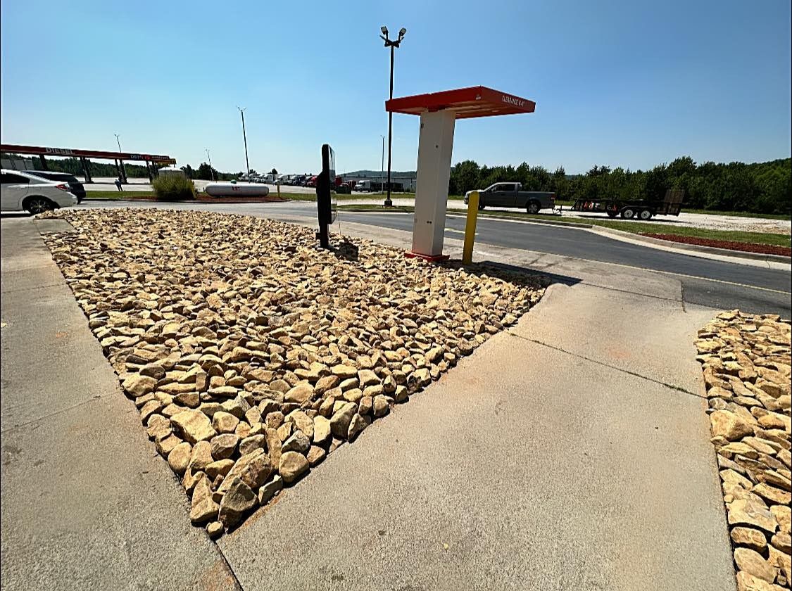 A concrete walkway with a red and white umbrella on top of it.