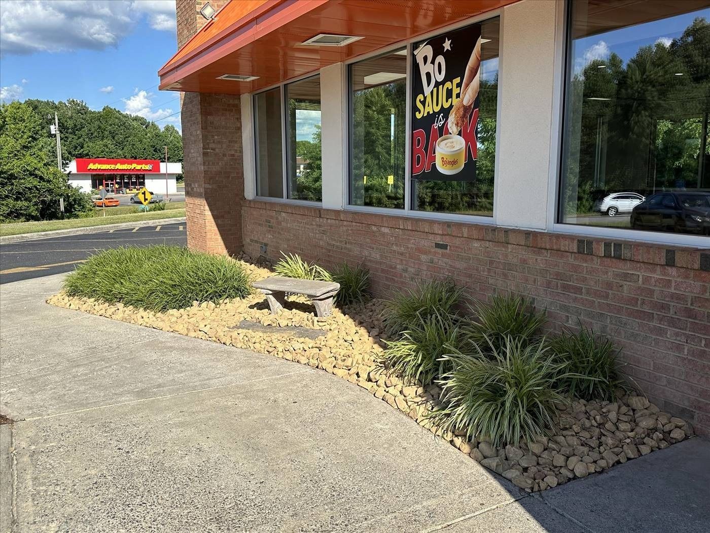 A brick building with a sign on the window that says `` bo snacks ''.