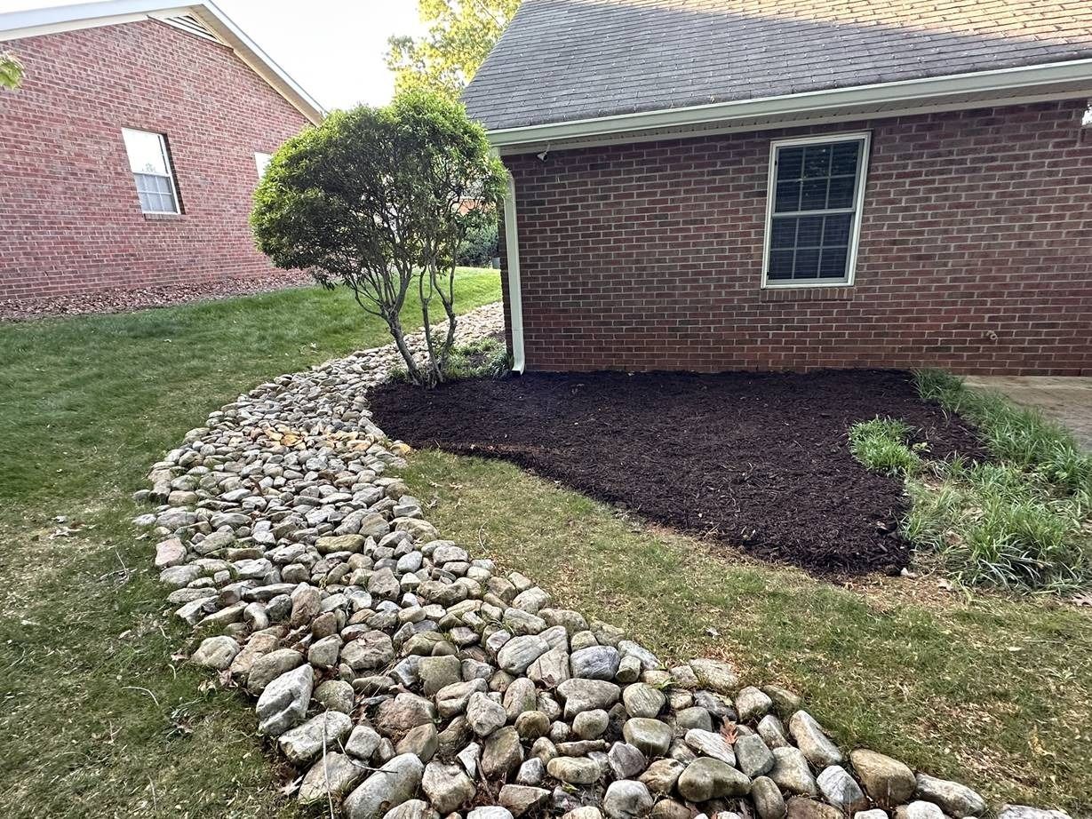 A brick house with a stone walkway leading to it.