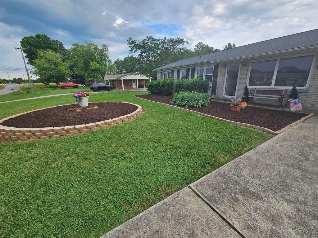 A house with a lush green lawn and a walkway in front of it.