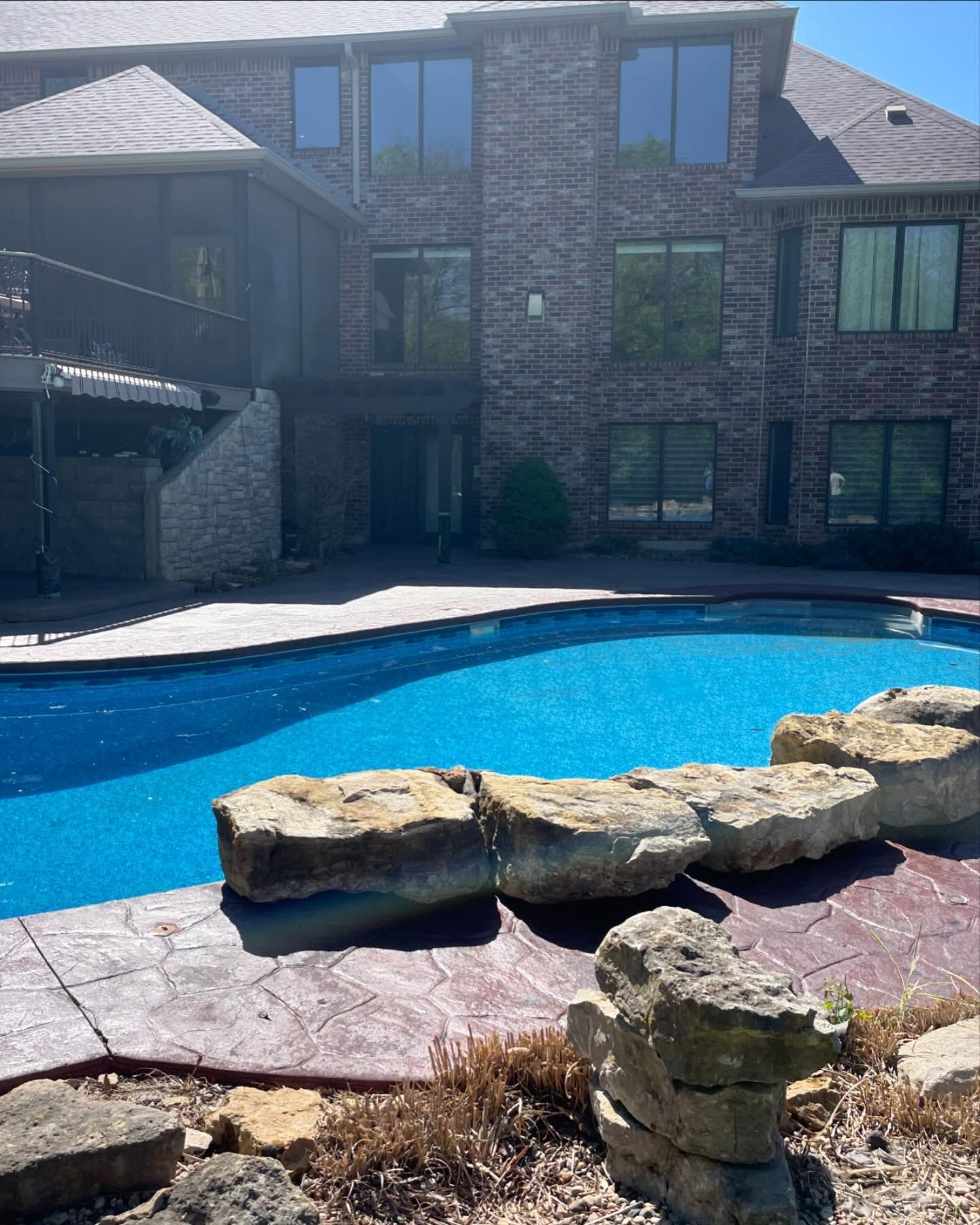 A large house with a large swimming pool in front of it