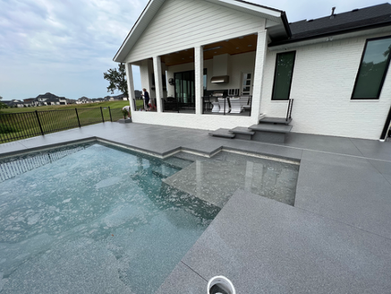 A large white house with a swimming pool in front of it.