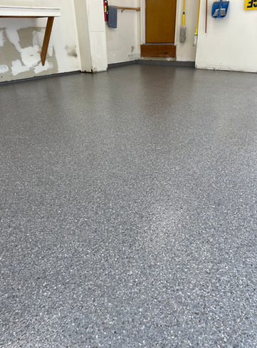 A room with a gray floor and white walls