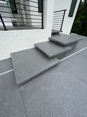 A set of stairs leading up to a balcony with a railing.