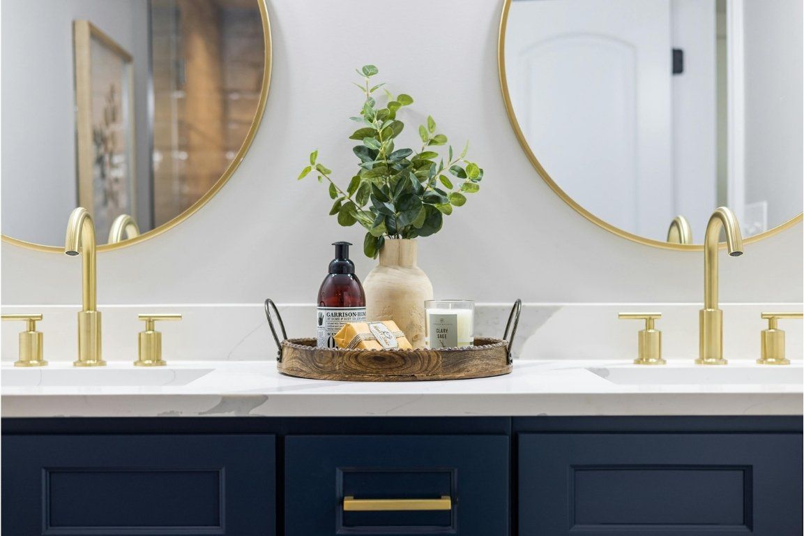 A bathroom with two sinks and two mirrors.