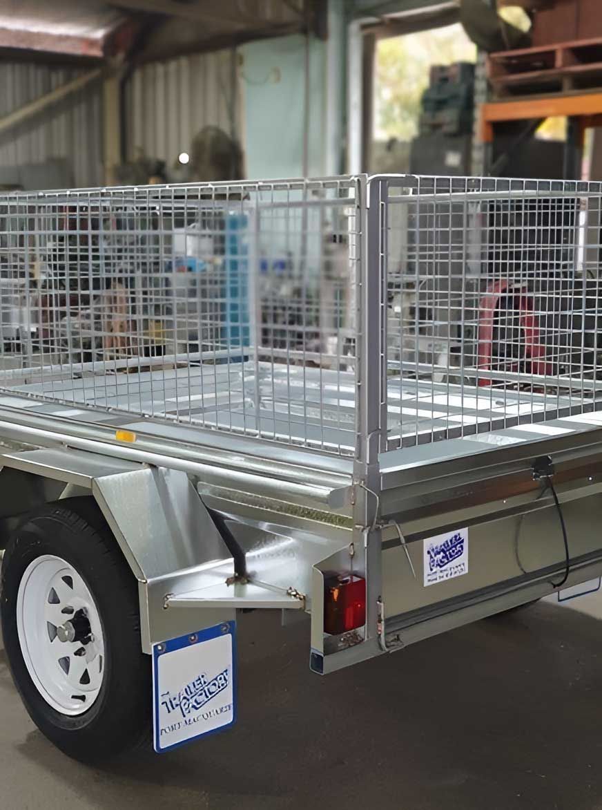 A Trailer With A Cage On The Back Is Parked In A Garage — Hastings Trailer Centre in Port Macquarie, NSW