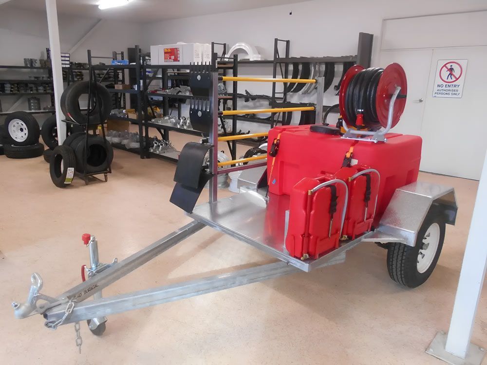 A Trailer With A Hose Reel Attached To It Is In A Store — Hastings Trailer Centre in Port Kempsey, NSW