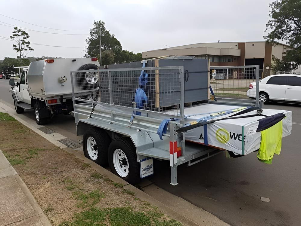 A Trailer Is Being Towed By A Truck On The Side Of The Road — Hastings Trailer Centre in Port Macquarie, NSW