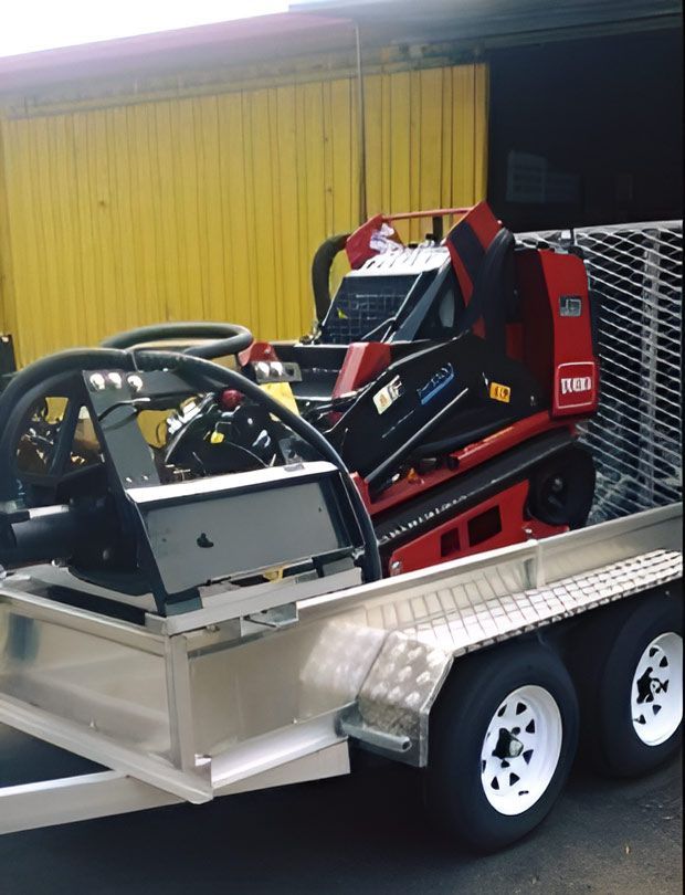 A Red And Black Lawnmower Is On A Trailer — Hastings Trailer Centre in Port Kempsey, NSW