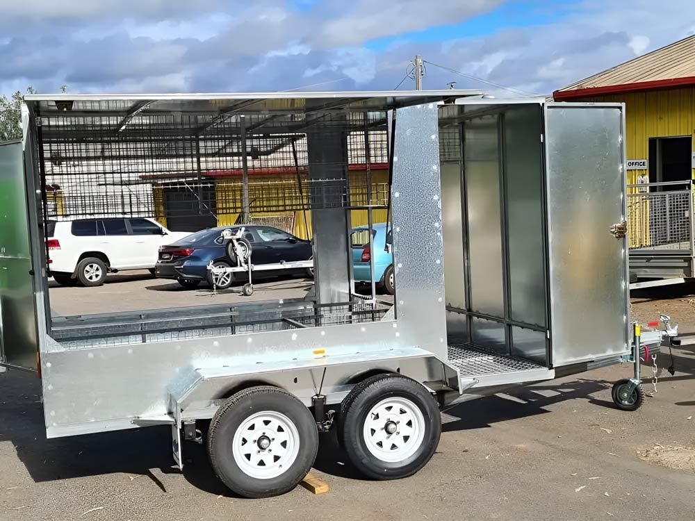 A Trailer With The Doors Open Is Parked In A Parking Lot — Hastings Trailer Centre in Port Kempsey, NSW