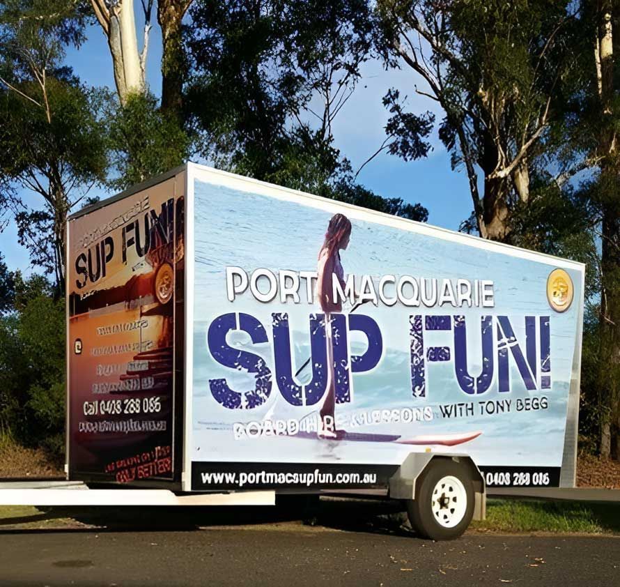 A Trailer For Port Macquarie Sup Fun Is Parked On The Side Of The Road — Hastings Trailer Centre in Port Macquarie, NSW
