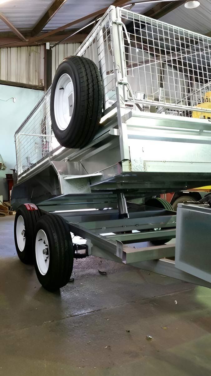 A Trailer With A Tire On Top Of It Is Parked In A Garage — Hastings Trailer Centre in Port Macquarie, NSW