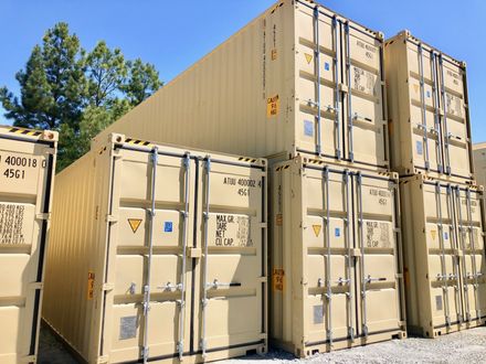 A row of shipping containers are stacked on top of each other