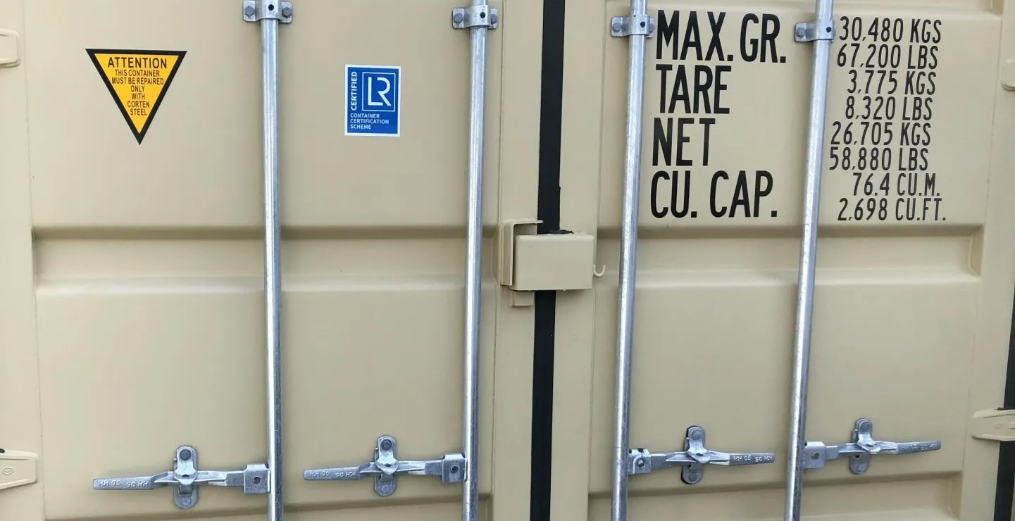 A shipping container has a max gr. tare net cu cap written on it