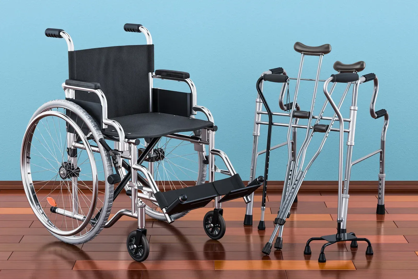 Wheelchair and pair of forearm crutches on a wooden floor in front of a blue wall.