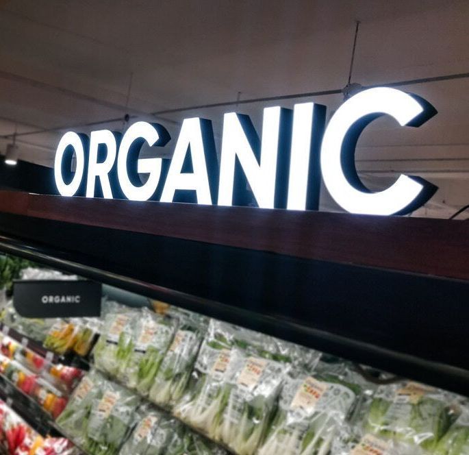 A Sign in a Grocery Store That Says Organic — Caledonian Colour In Chevallum, QLD