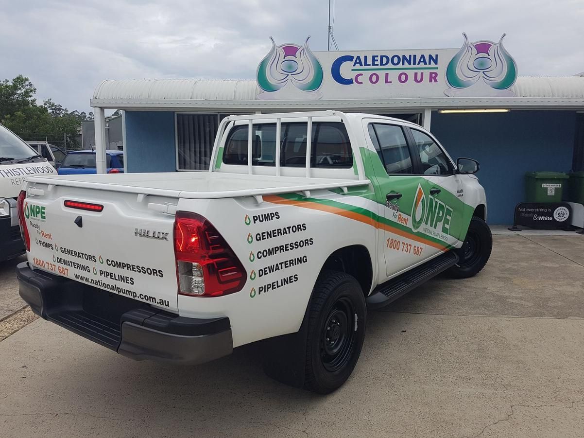 A White Truck is Parked in Front of a Building That Says Caledonian Colour — Caledonian Colour In Chevallum, QLD