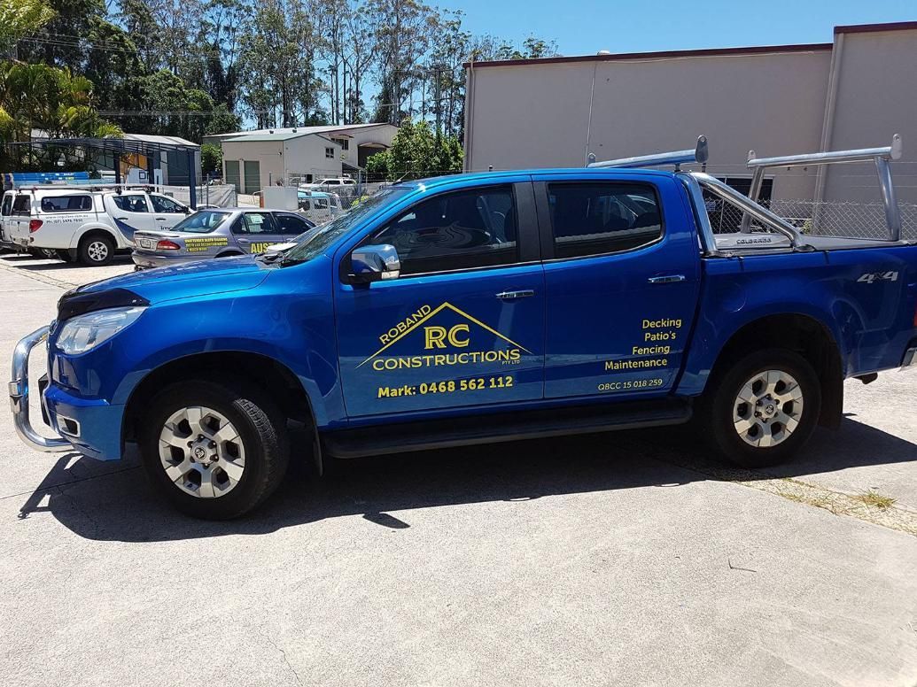 A Blue Truck With the Word Rc on the Side is Parked in a Parking Lot — Caledonian Colour In Noosa, QLD