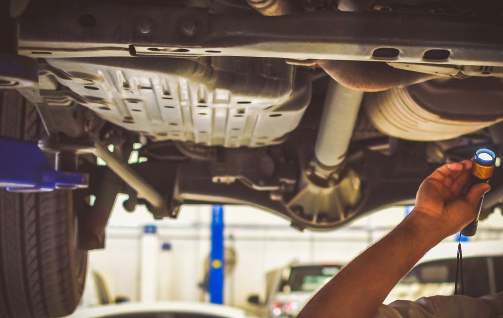 Mechanic Inspects Car Underside — Jims Auto Care in Berrimah, NT