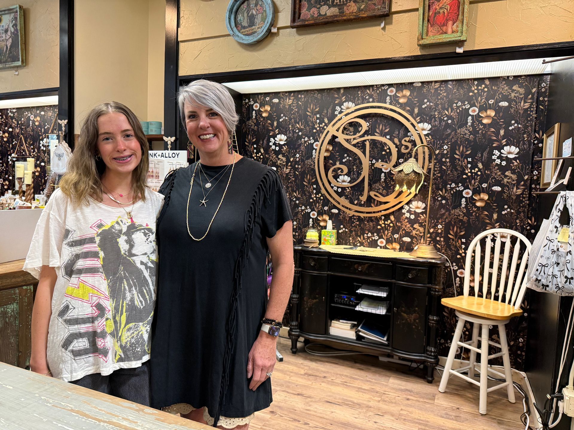 Two women are standing next to each other in a store.