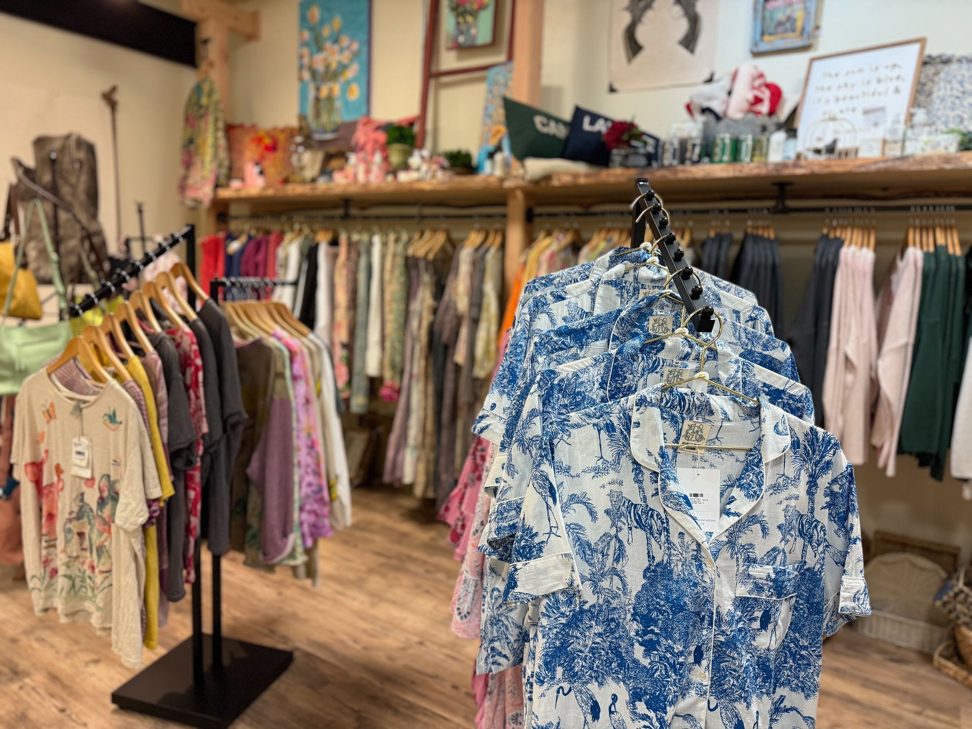 A store filled with lots of clothes hanging on racks.