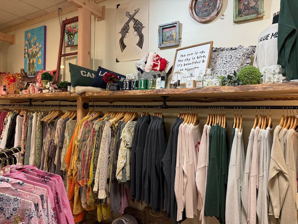 A store filled with lots of clothes hanging on racks.
