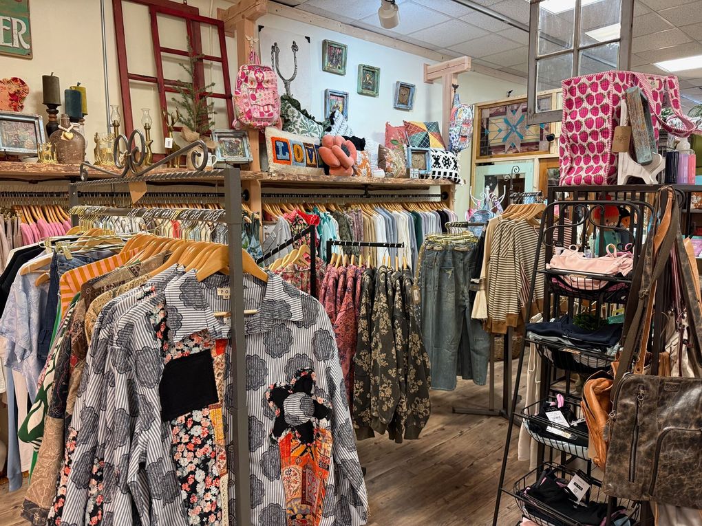 A store filled with lots of clothes hanging on racks.