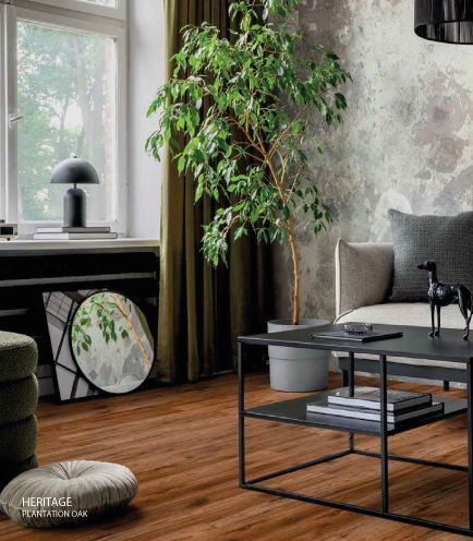 Una sala de estar con un sofá, una mesa de café y una planta.