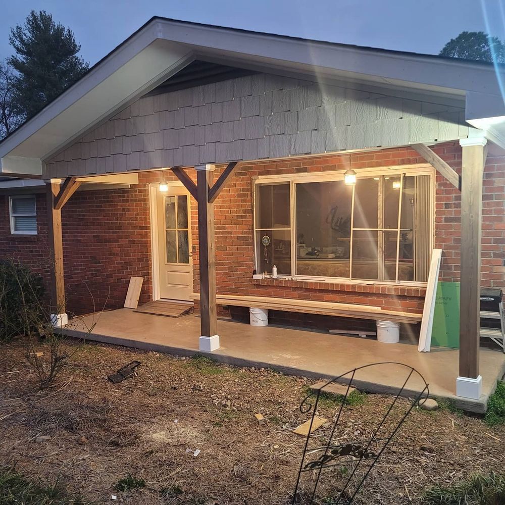 Brick house with a porch, dark wooden beams, and string lights.