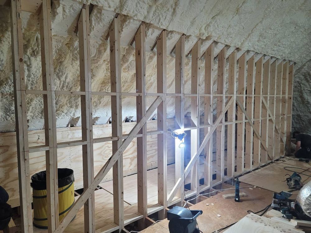 Wooden frame construction inside a cave, with plywood floor and rock wall.
