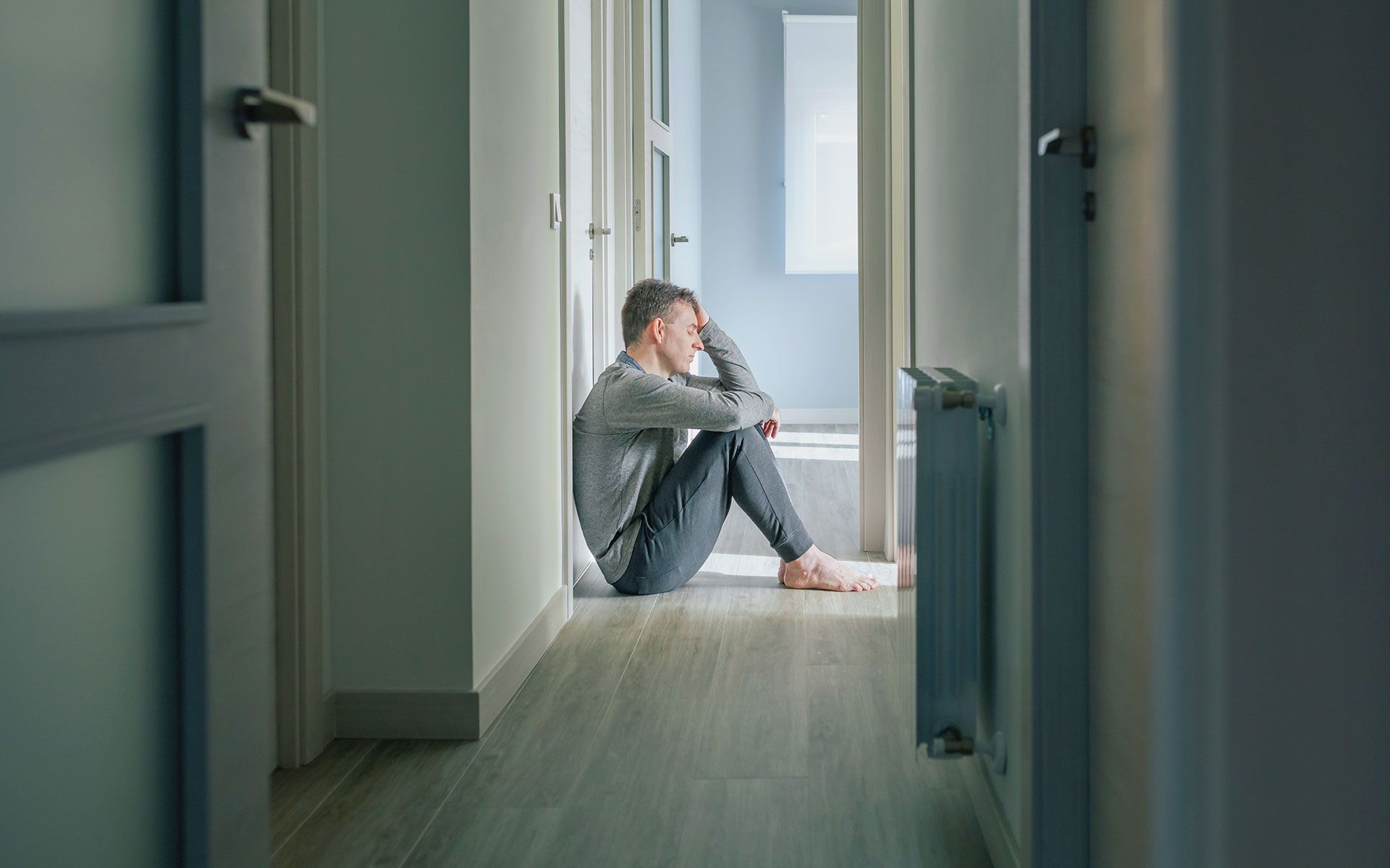 A man wearing gloves is working on a pipe