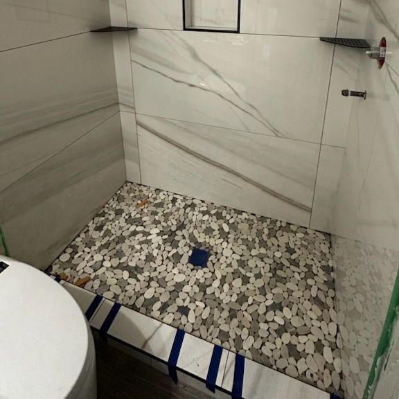 A bathroom with a walk in shower and a toilet