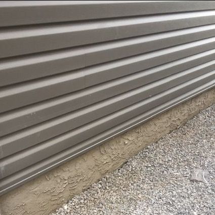 A close up of a siding on the side of a building.