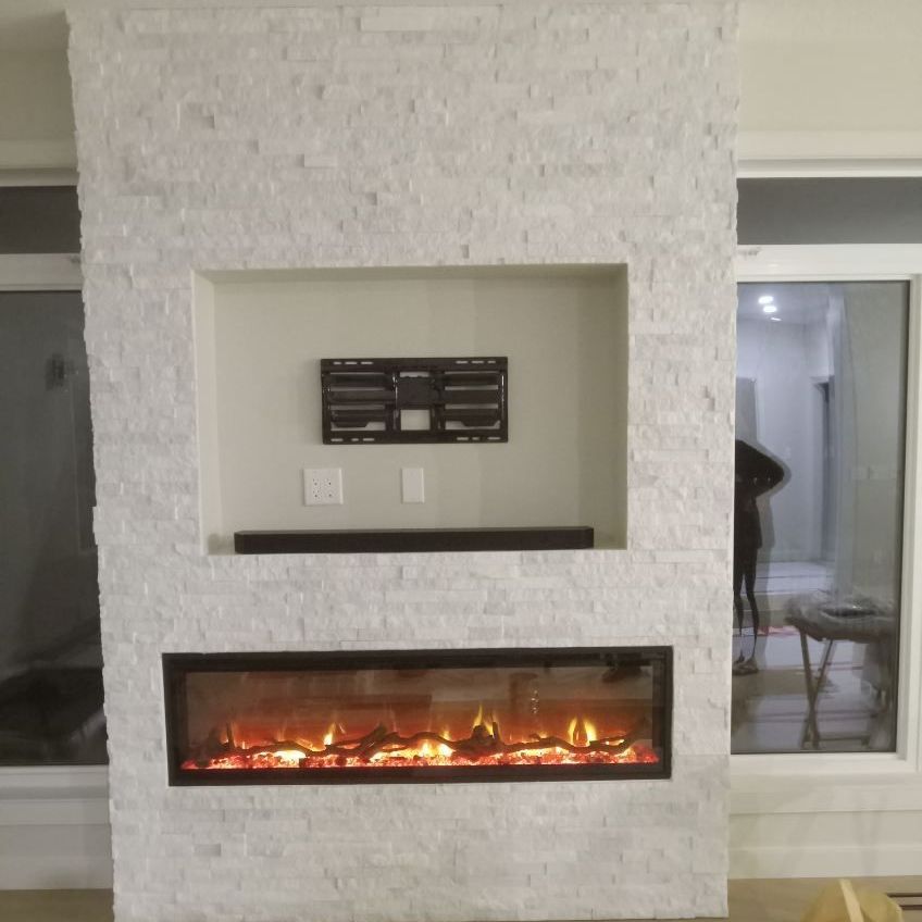 A fireplace with a flat screen tv mounted on the wall.