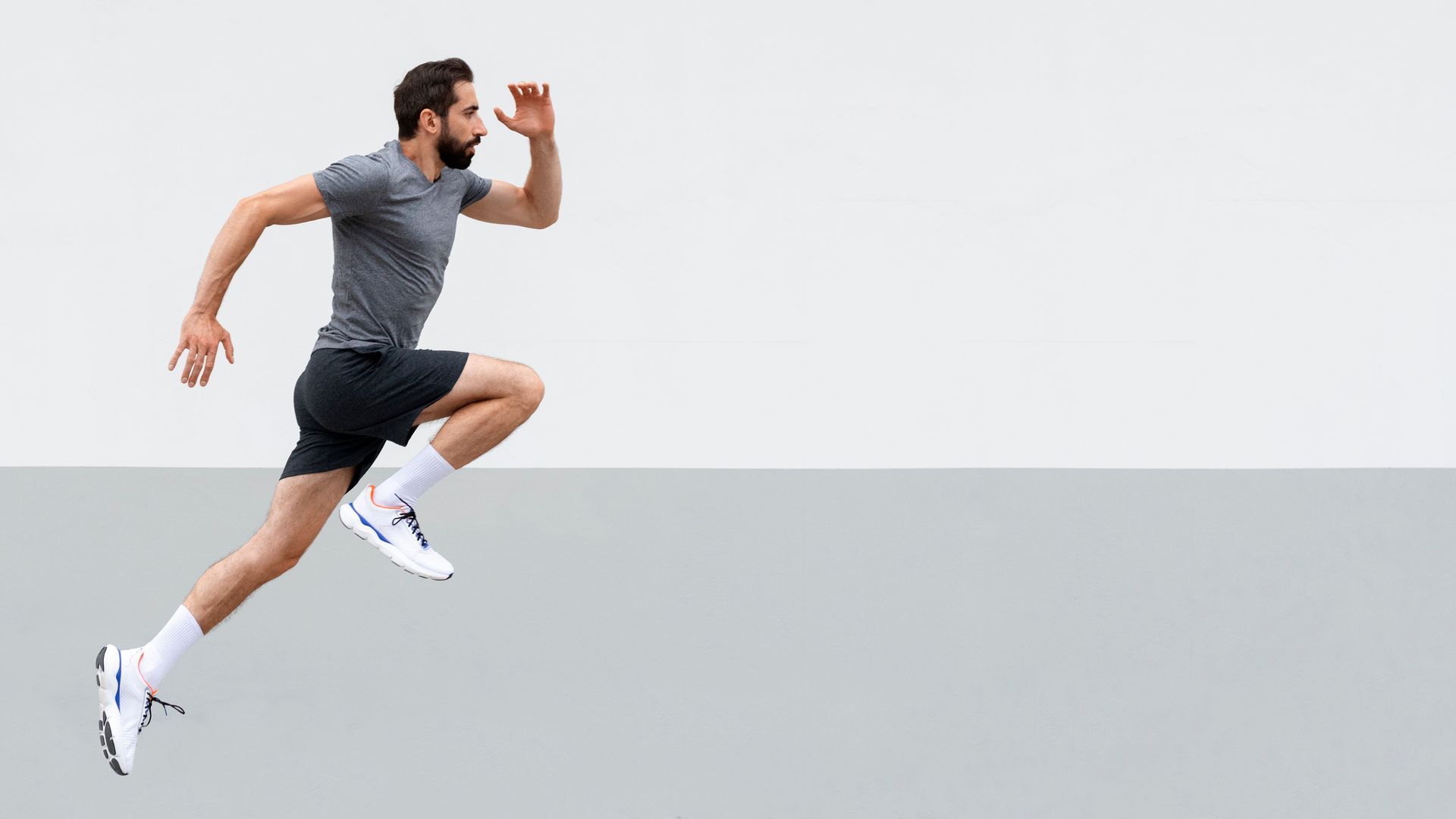 a man is jumping in the air while running .