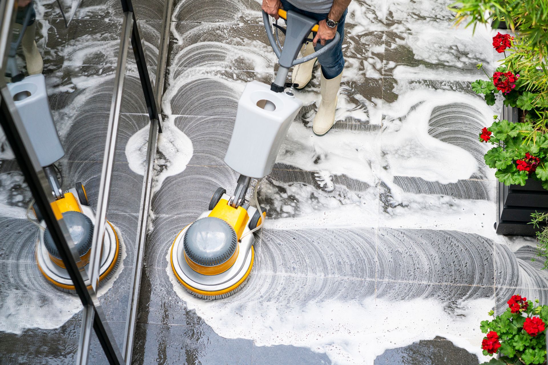 A man is cleaning the floor with a machine.