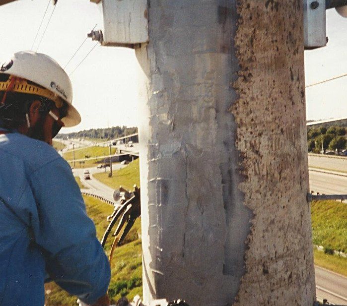 Smoothing newly applied Concrete Pole Repair (CPR) to an form an even surface