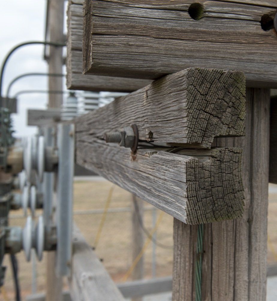 Utility Pole being placed in hole by a crane