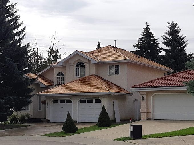 A house with a wooden roof and two garage doors