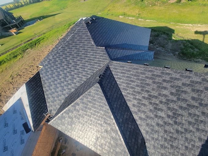 An aerial view of a house with a roof that is being installed.
