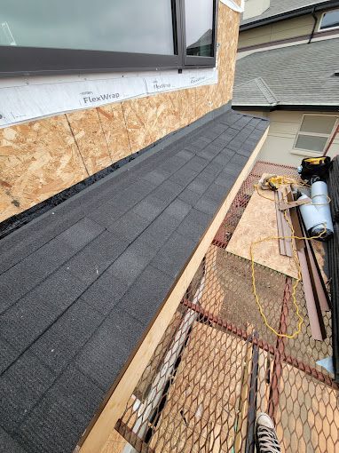 A roof is being installed on the side of a building.