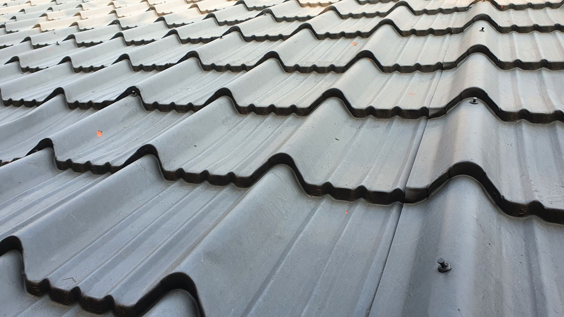 A close up of a metal roof with waves on it.