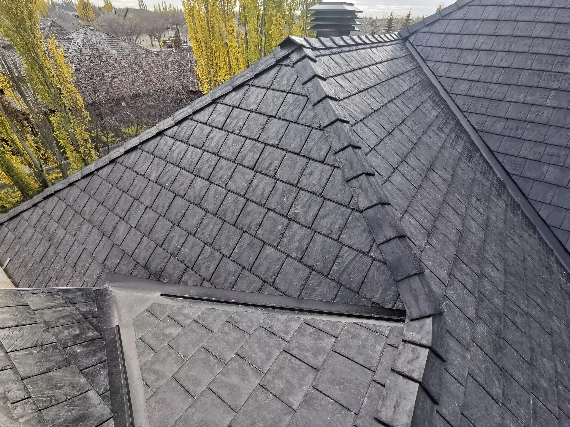 A close up of a roof with slate tiles on it.