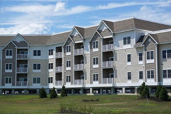A large apartment building with a lot of windows and balconies