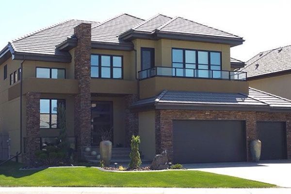 A large house with two garages and a balcony
