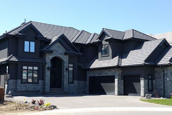 A large black house with a gray roof