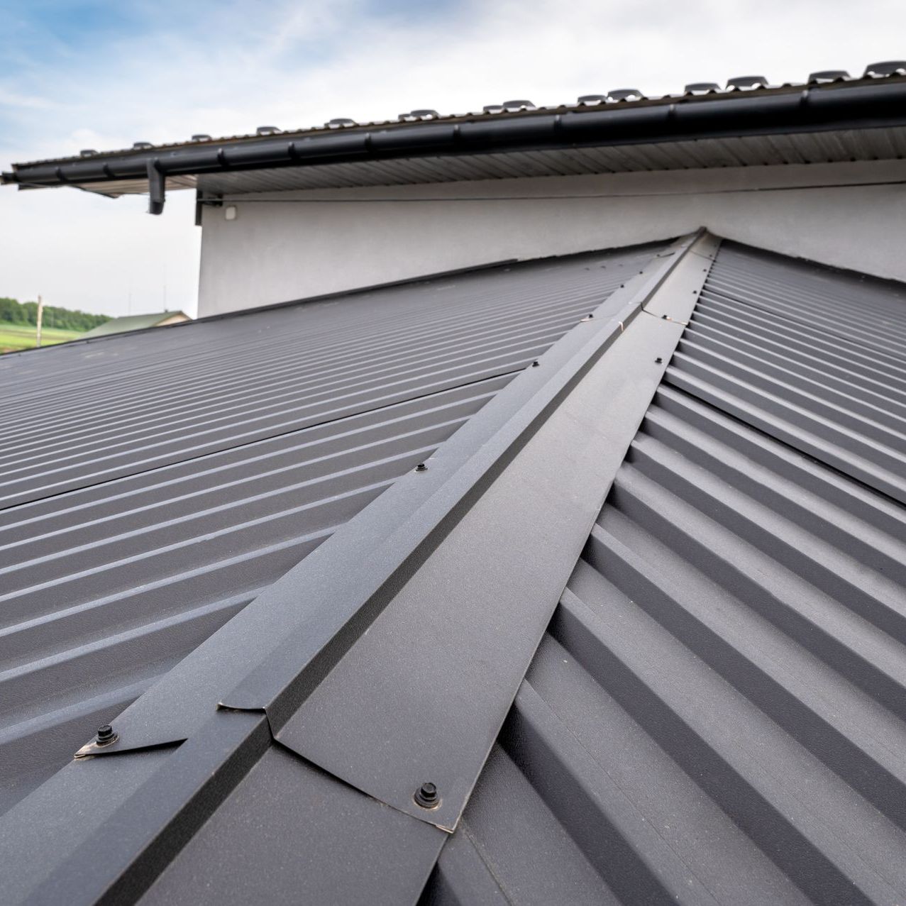 A close up of a gray metal roof on a house