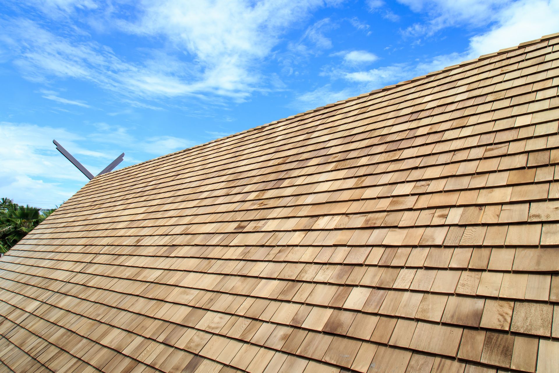 A wooden roof with a blue sky in the background