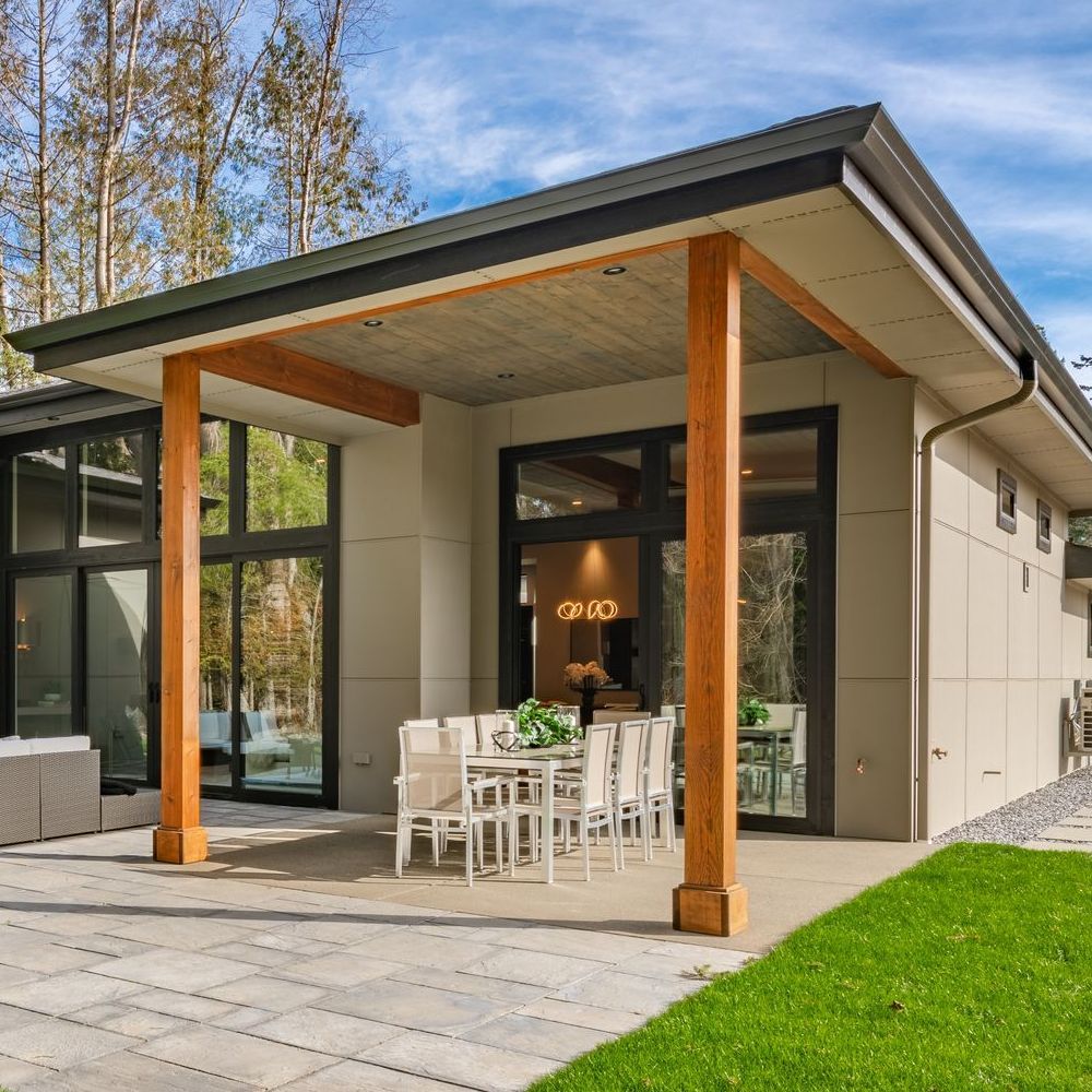 A small house with a covered patio and tables and chairs