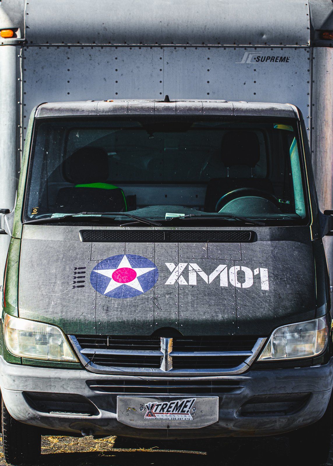 Cab wrap on tractor trailer. Wrap has star and XM01 representing Xtreme! Marketing being established in 2001